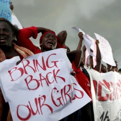 Women react during a protest demanding security forces to search harder for 200 abducted schoolgirls, outside Nigeria’s parliament in Abuja